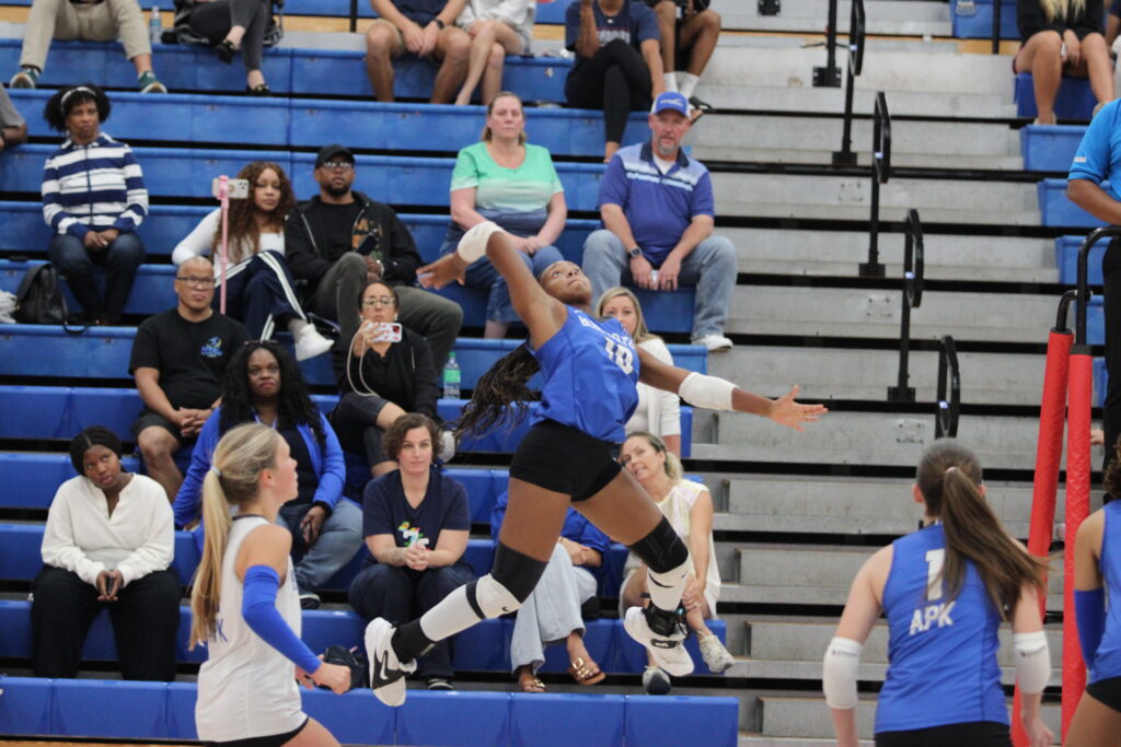 Marie Hughes rises up to spike a ball at Lake Brantley.
