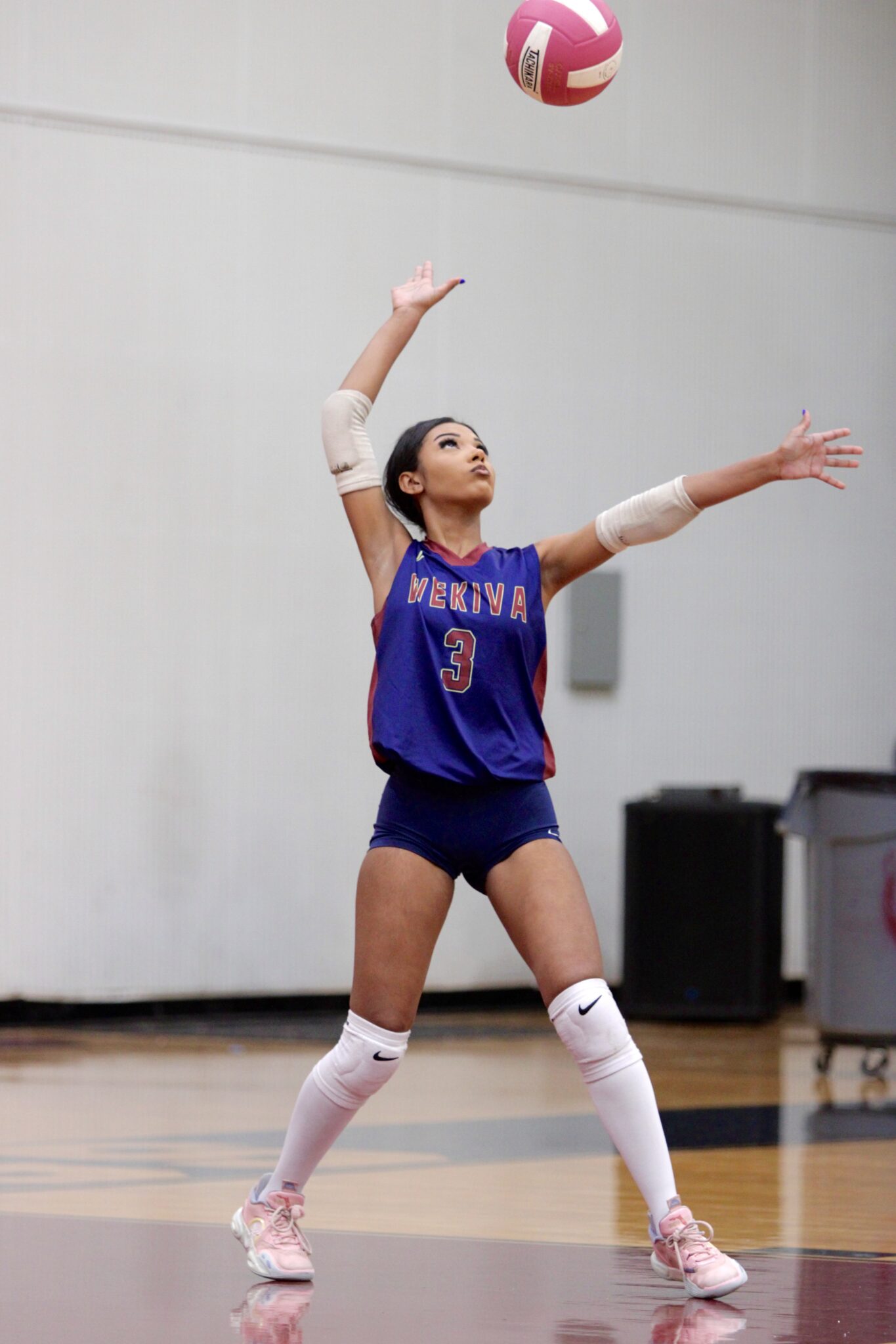 Mikayla Rivera tosses up a ball to serve to Edgewater.