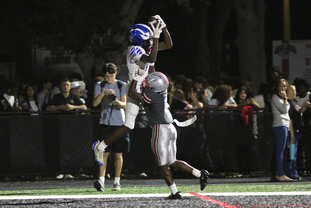 Nyzier Collington Mosses a Lake Mary defender for a touchdown.