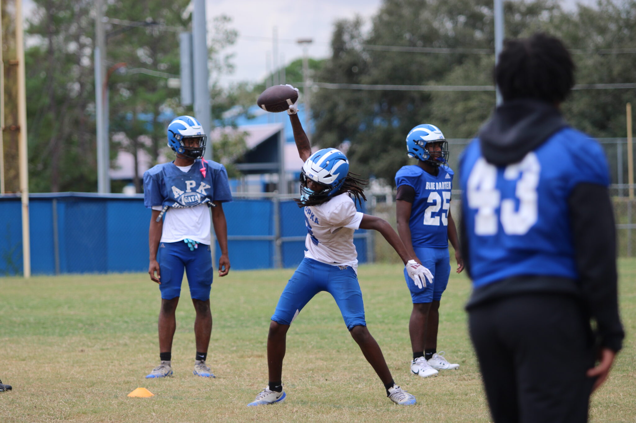 Nyzier Collington spikes the ball after a catch in the end zone at practice.