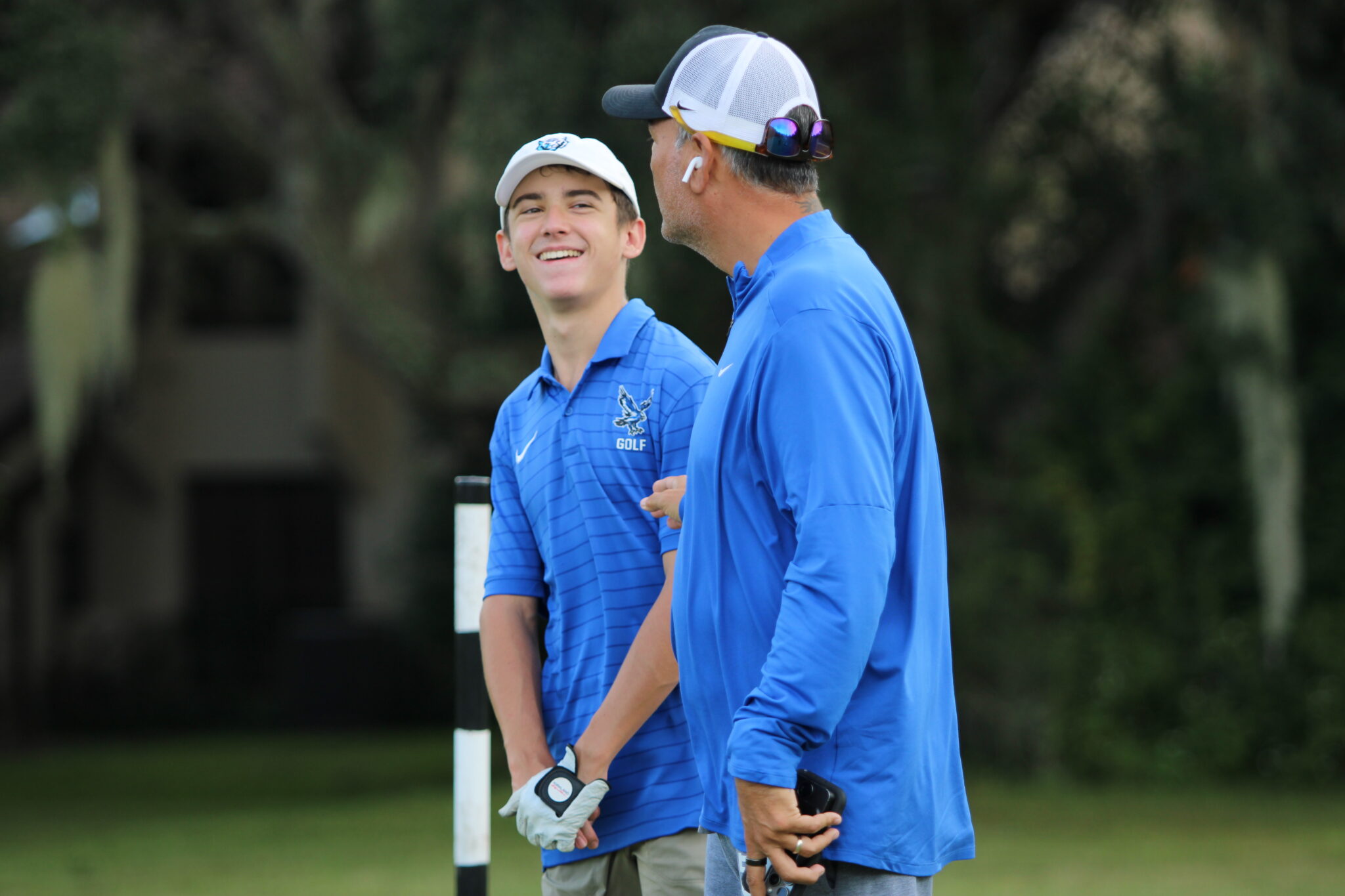 Owen Ancona and coach Christian Lundy communicate and share a laugh.