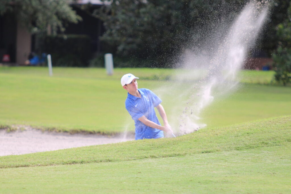 Owen Ancona hits his ball out of a bunker.