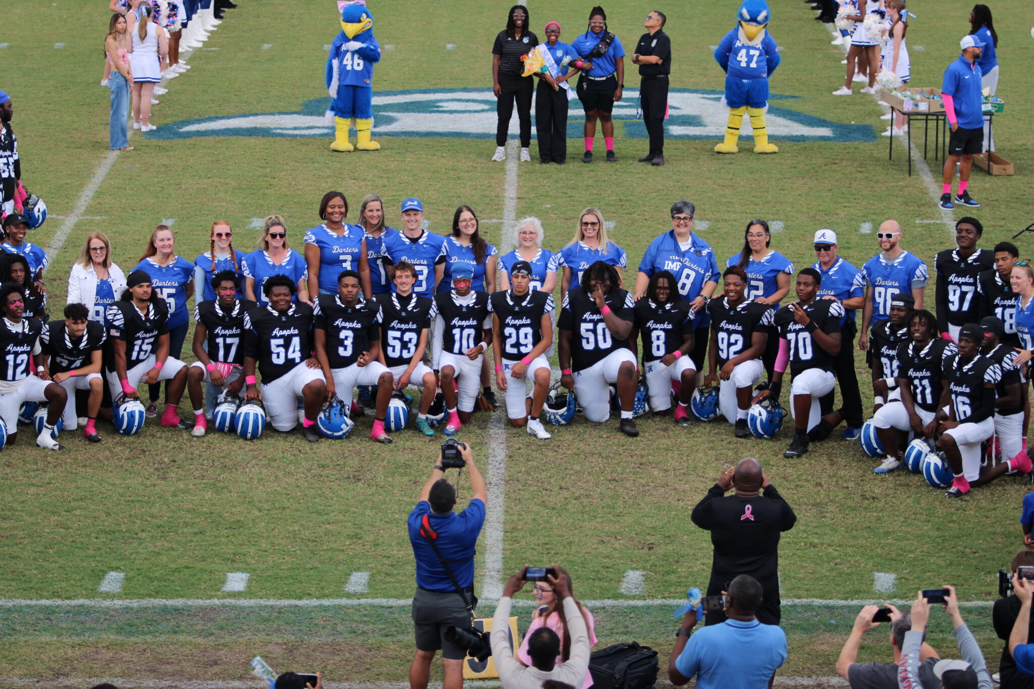 Senior Blue Darters line up with teachers on Senior Night.