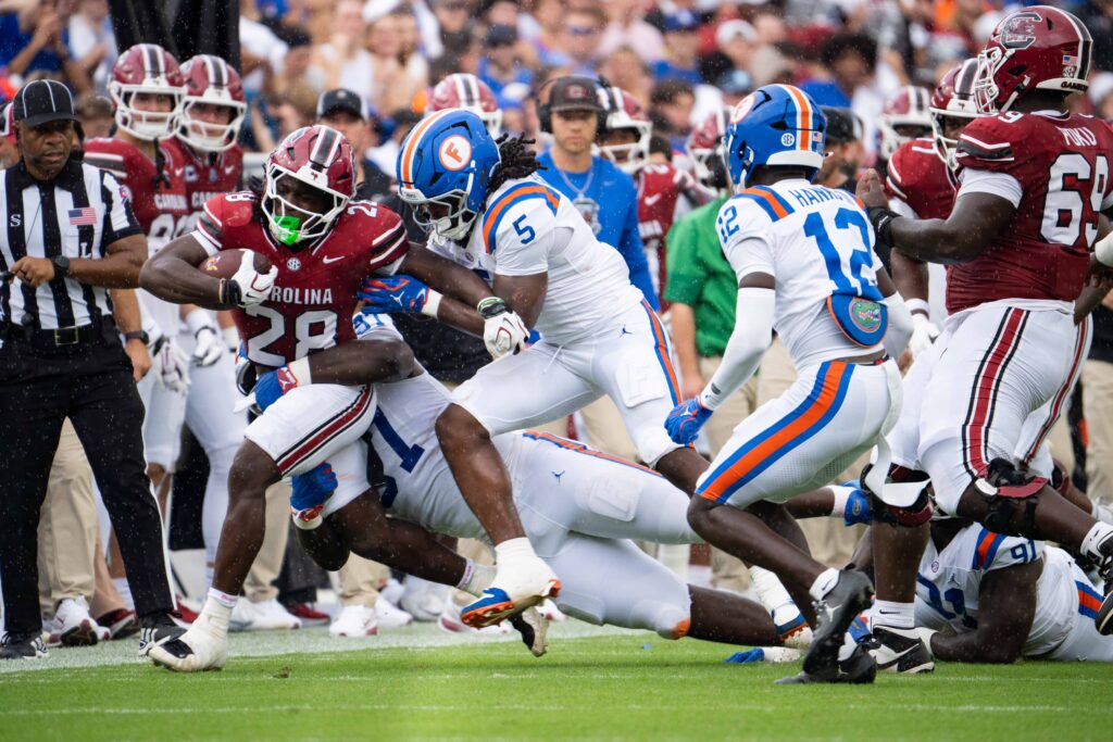 UF linebacker Myles Graham wraps up South Carolina running back Matt Fuller during Saturday’s game at Ben Hill Griffin Stadium.