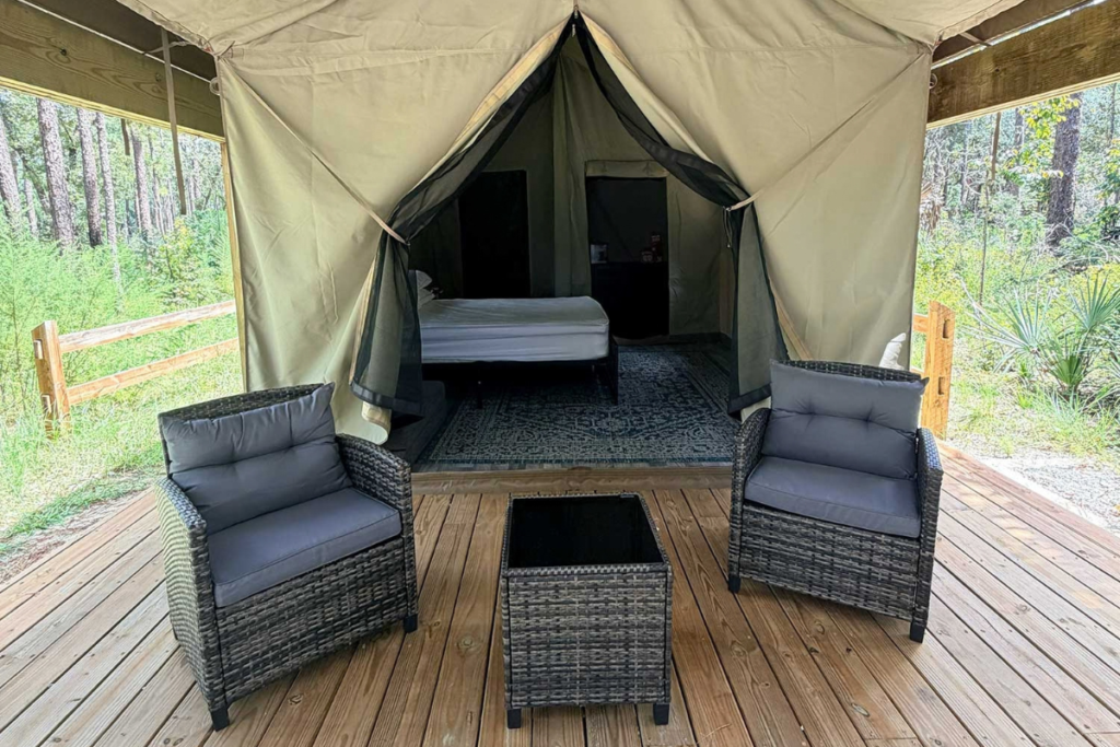 One of four new glamping tents at Wekiwa Springs State Park features a queen-size bed and a covered deck with seating. The tents, located in the park's campground, are now available for overnight reservations.