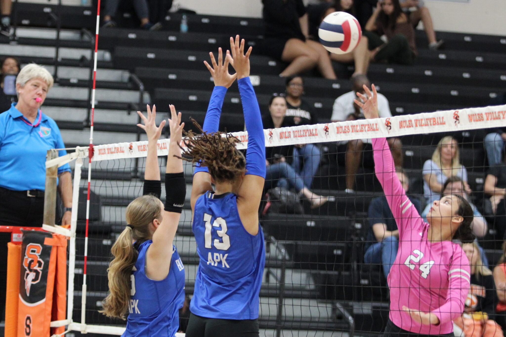 Victoria Polusmak and Kierra Taylor reach up in attempt to block a hit from Seminole.